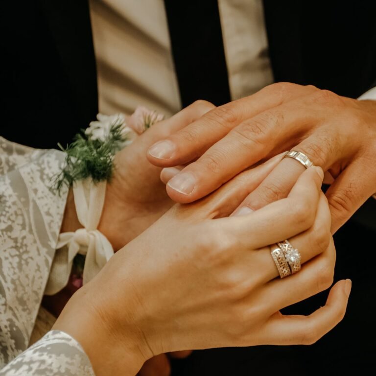 Couple placing wedding rings