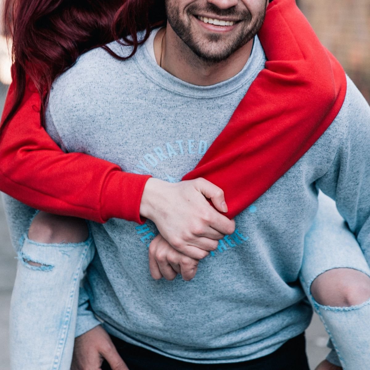 A girl riding piggyback on her boyfriend