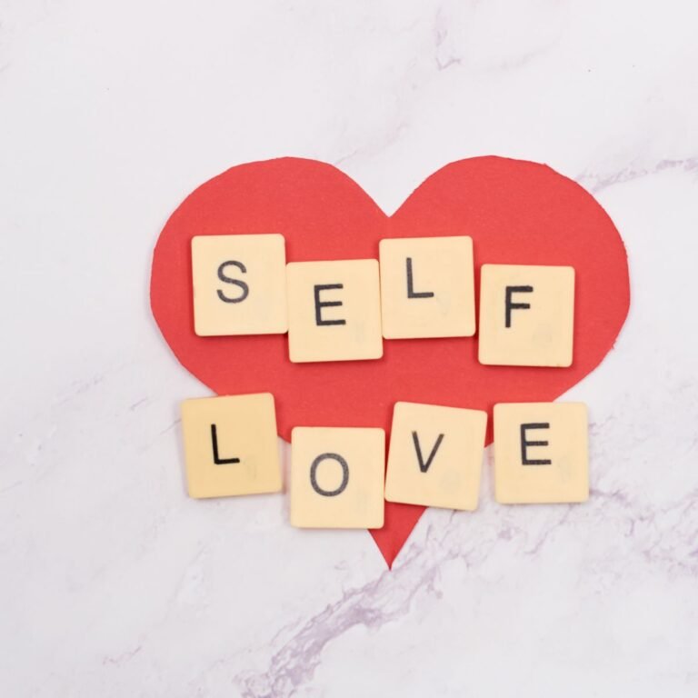 Self love written in scrabble tiles